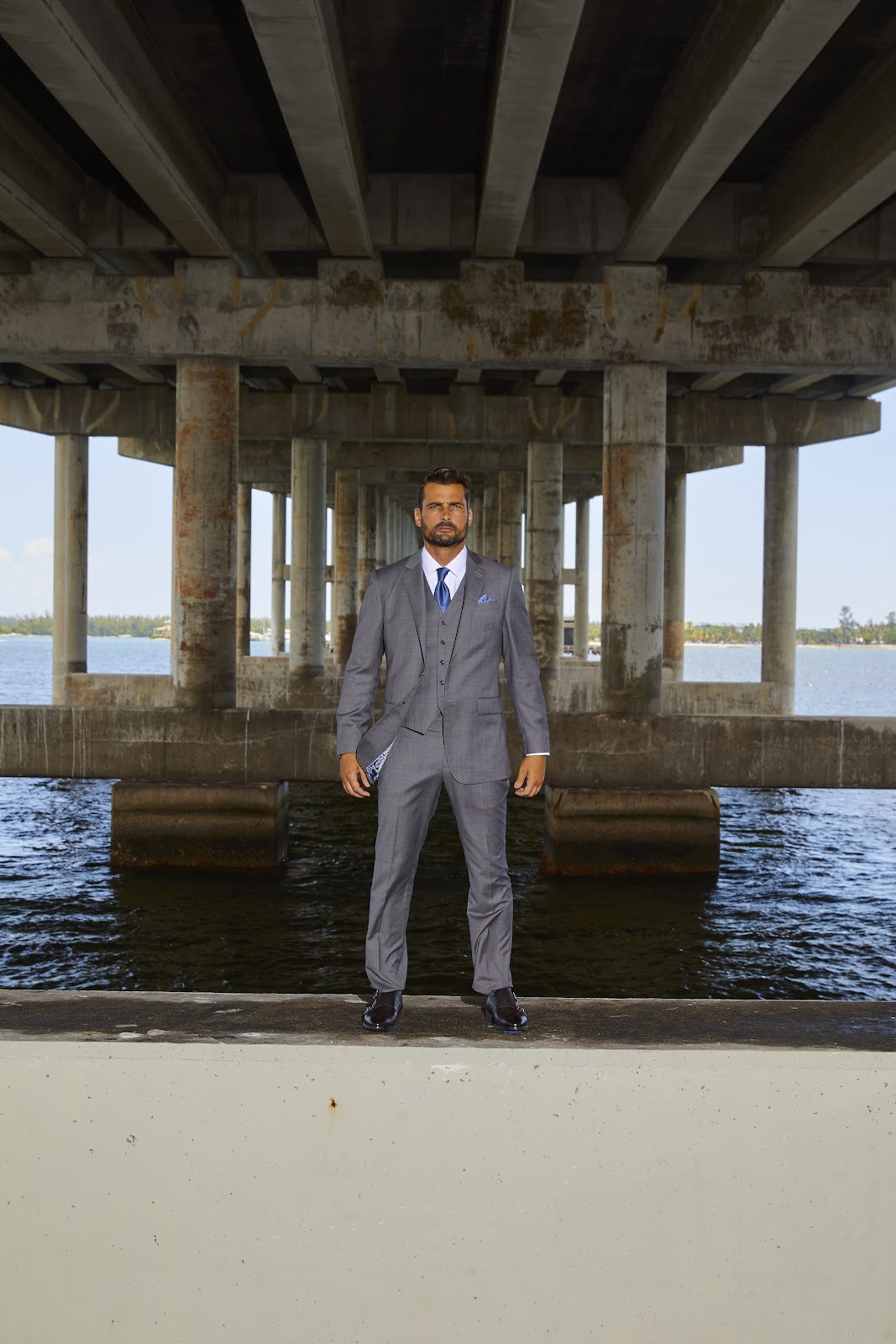 A sophisticated three piece vested custom suit in grey showcasing expert tailoring and flawless fit